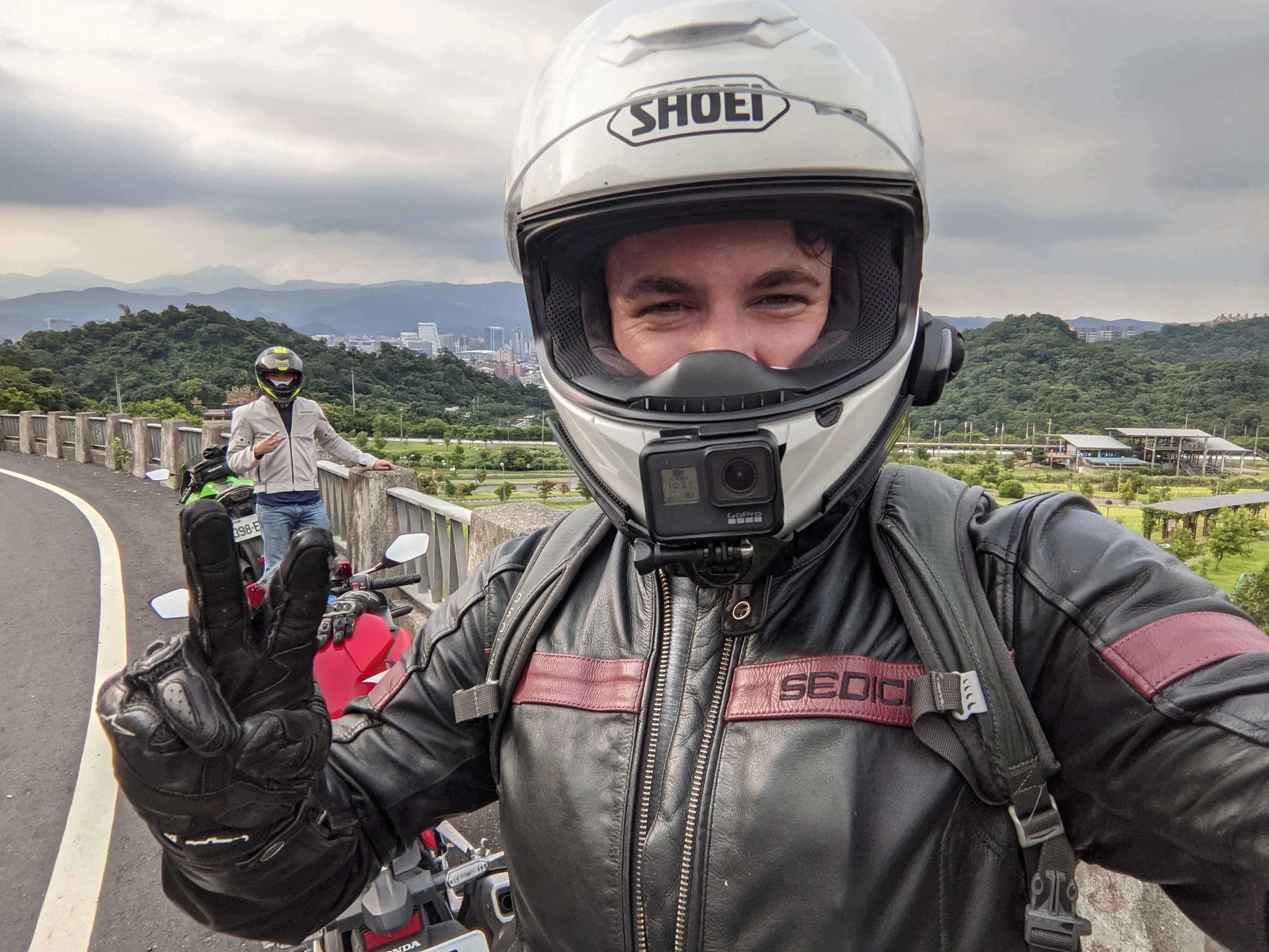 Caleb posing with his motorcycle in the mountains near Taipei.